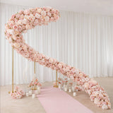 Pastel pink floral wedding arch with pink aisle and candles