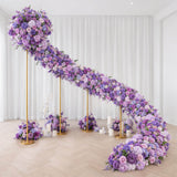 Lavender and purple floral installation with gold stands in a modern white room