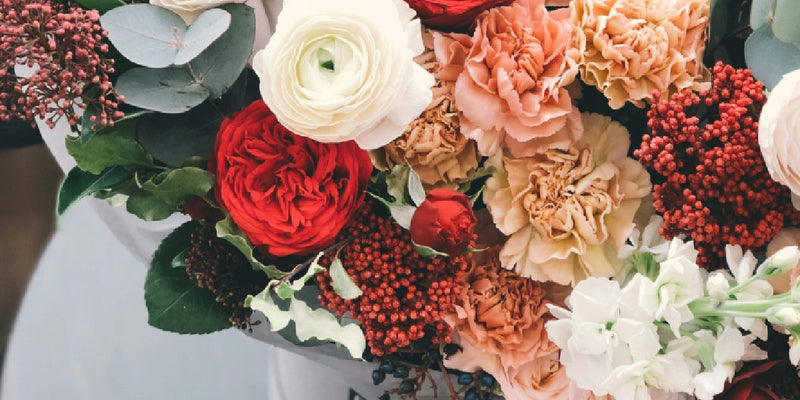 Artificial flower arrangement with roses and carnations