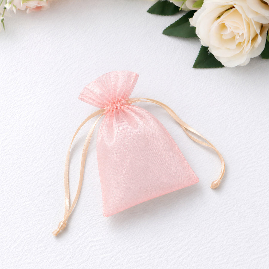 Pink organza gift bag with drawstring on white background