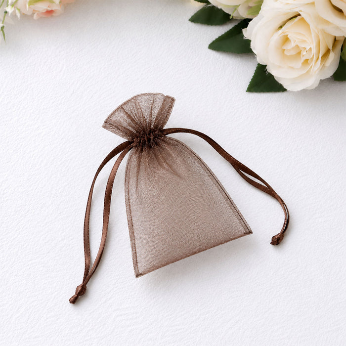 Brown sheer organza gift pouch with drawstring on white background