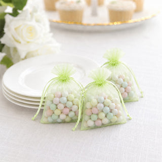 Pastel candy wedding favor bags with plates and white rose centerpiece