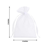 White organza drawstring gift bag on soft white fabric with floral border
