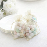 Pastel candy-filled organza bags for party favors or decorations.