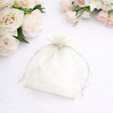 White organza drawstring bag on a plain background