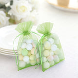Green organza bags filled with pastel-colored decorative eggs.