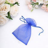 Blue organza gift bag with drawstring, perfect for party favors.