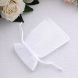 White organza gift pouch with drawstring on soft fabric with roses
