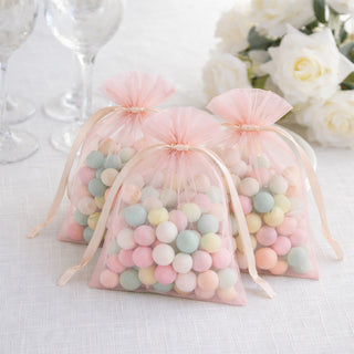 Pastel candy-filled favor bags with sheer pink drawstring