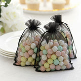Three sheer black bags filled with pastel-colored decorative balls.