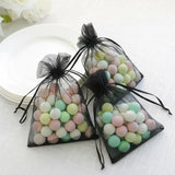 Colorful candy-filled organza bags for gift wrapping.