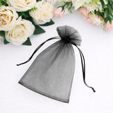 Black organza gift bag with drawstring on a white background.