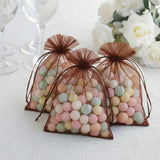 Colorful candy-filled organza bags for party favors.