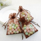 Colorful candy-filled organza bags for party favors.