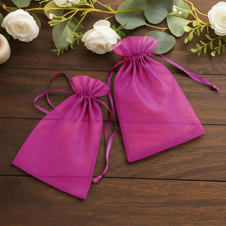 Purple organza gift bags on a wooden table with floral accents.