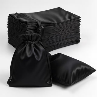 Stack of black satin bags with a drawstring closure on a white background.