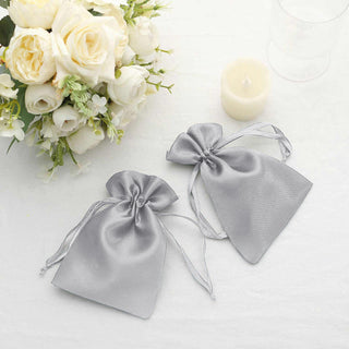 Silver satin drawstring bags for gifts or party favors.