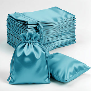 Teal satin drawstring bags stacked and displayed on a plain background.