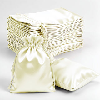 Elegant satin drawstring bags in ivory with matching bags on a white backdrop.