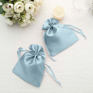 Two light blue satin drawstring bags on a soft white background.