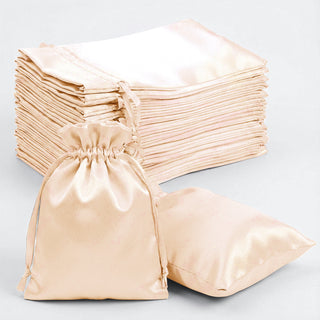 Set of silk drawstring bags in soft beige, ideal for gifts or storage.