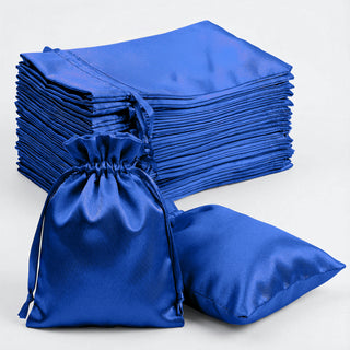 Blue satin drawstring bags and pouches stacked together.