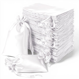 Stack of white satin drawstring bags on a white background