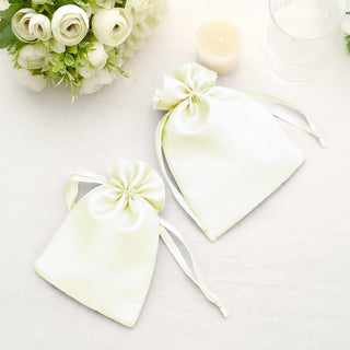 Two elegant satin gift bags with ribbon ties on a light background.