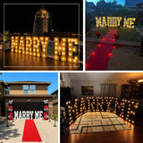 Oversized illuminated marquee letters used indoors for a romantic proposal and party décor display
