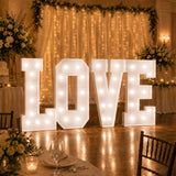 Illuminated LOVE letters at a romantic wedding reception backdrop