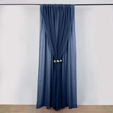 Navy blue curtain with floral tieback on a plain background