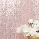 Floral arrangement with white roses on a pink sequined background.