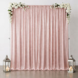 Pink sequin backdrop with floral accents and lanterns for events or photo shoots.