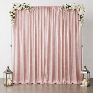 Pink sequin backdrop with floral accents and lanterns for events or photo shoots.