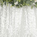 White lace fabric with intricate floral patterns and greenery accents.