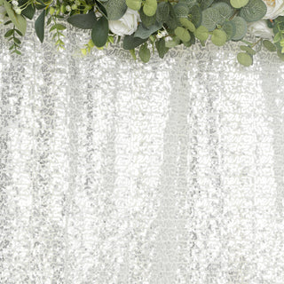 White lace fabric with intricate floral patterns and greenery accents.