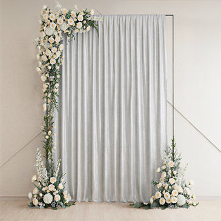 Elegant silver curtain with floral accents on either side.