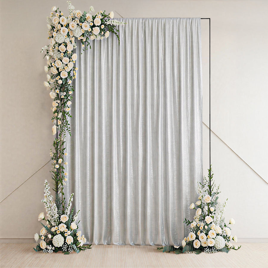 Elegant silver curtain with floral accents on either side.