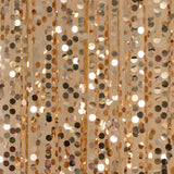 Gold and silver sequin curtain with shimmering reflective discs