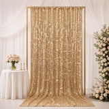 Gold sequin wedding backdrop with white floral arrangements and table decor