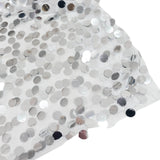 White sequin fabric close-up with reflective silver discs