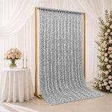 Silver sequin wedding backdrop curtain on gold frame with floral decor