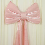 Large pink satin bow decoration on a soft backdrop.