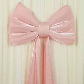 Large pink satin bow decoration on a soft backdrop.