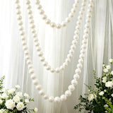 Elegant white pearl garland decor with sheer drapes and roses for wedding backdrop