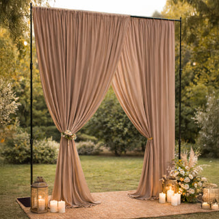 Elegant beige drapery with lanterns and candles for outdoor event decor.