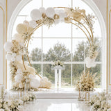 Elegant white and gold balloon arch wedding backdrop with floral arrangements