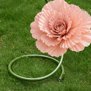 Pink decorative flower garden hose on grass