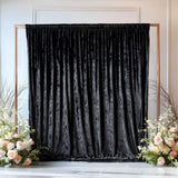 Velvet backdrop with floral arrangements for events or photo shoots.