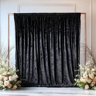 Velvet backdrop with floral arrangements for events or photo shoots.